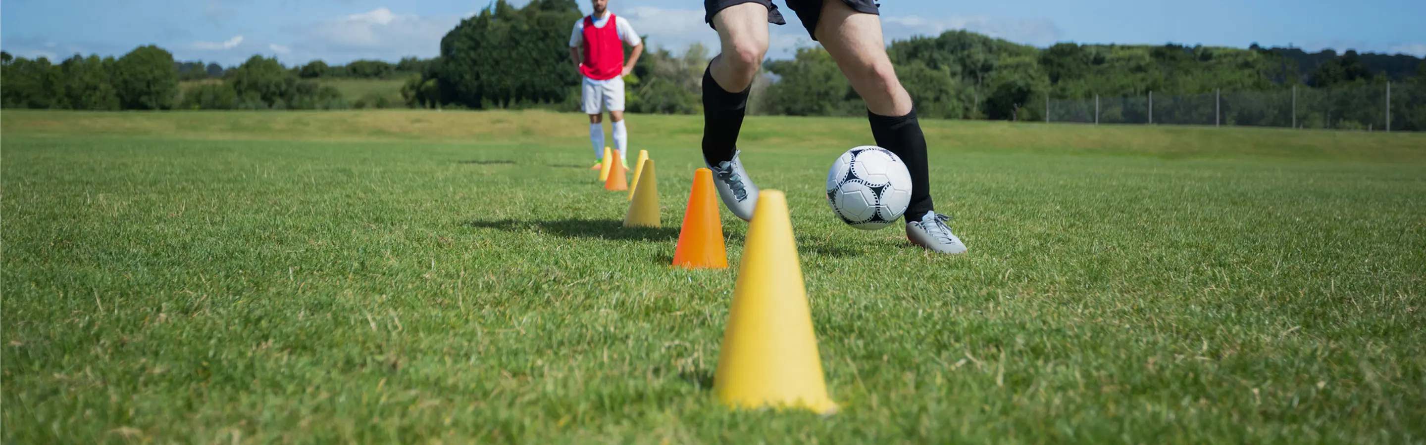 Soccer training with cones in a field.