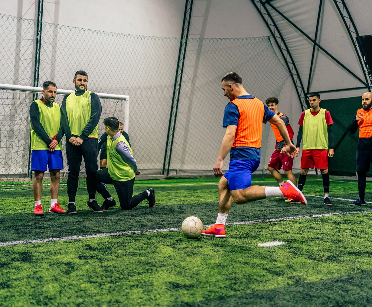Indoor soccer practice with focused players.