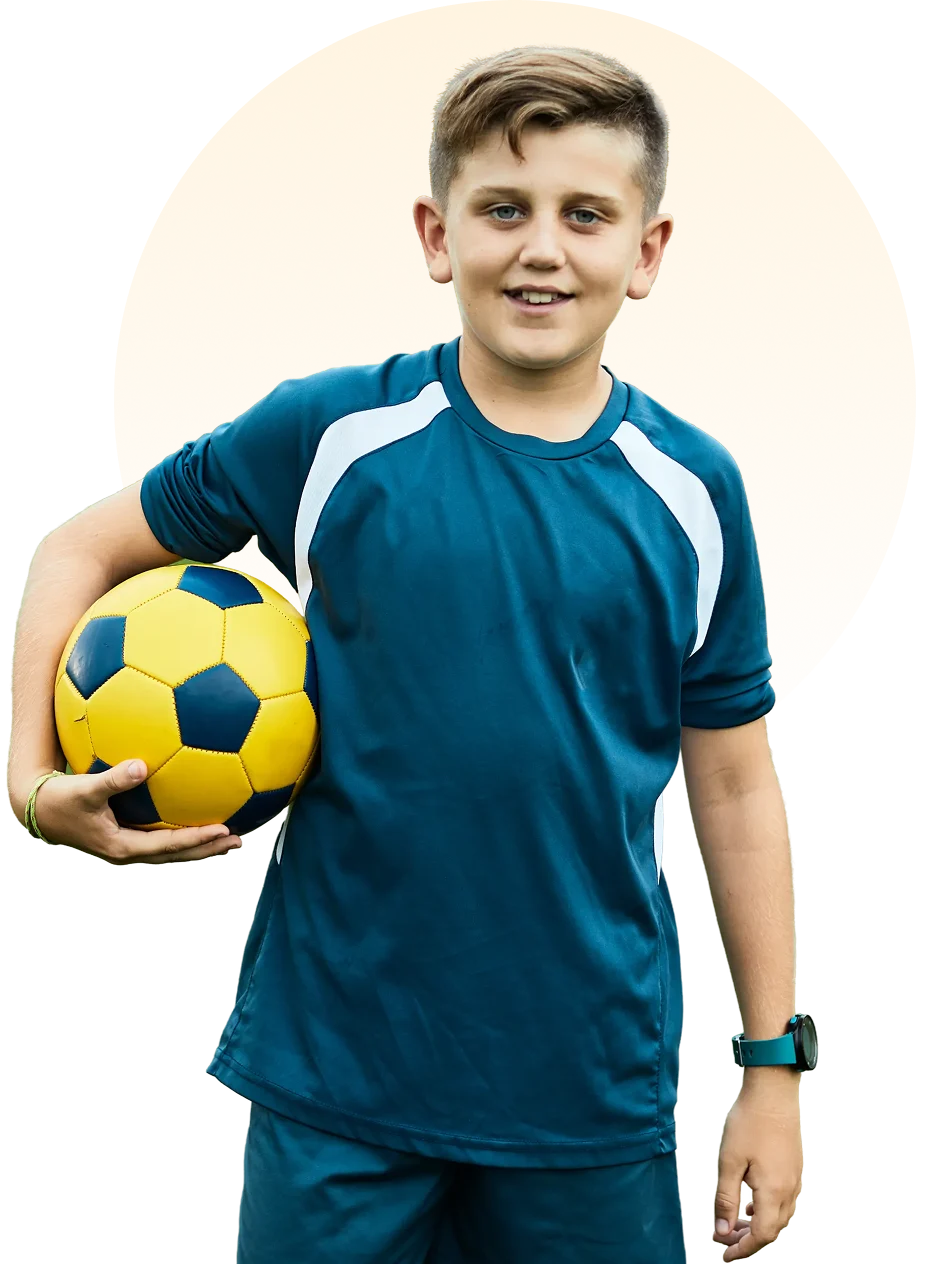 Smiling boy with sports watch and ball