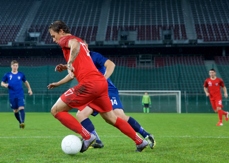 Soccer player dribbling during a match.